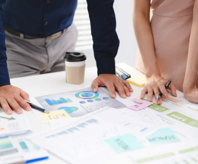Serious diverse business team leader discuss financial paperwork, Smart businessman | Axelerant